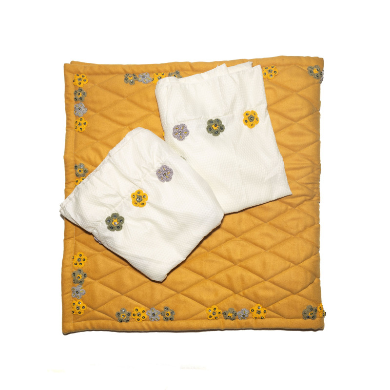 Yellow prayer mat with a prayer set